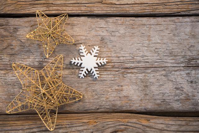 Star and snowflake on wooden plank during christmas time