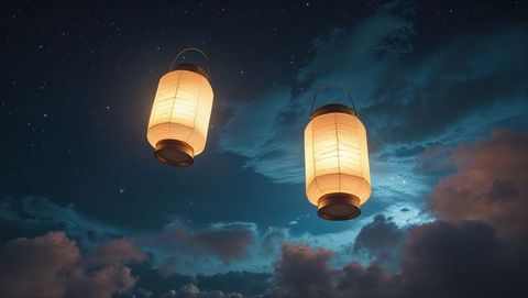 Floating lovers paper lanterns illuminating starry night sky