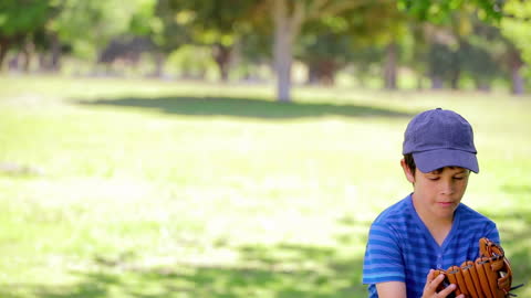 Young Boy Enjoying Baseball in Lush Countryside