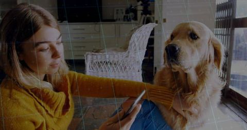Woman Using Smartphone While Relaxing with Golden Retriever at Home