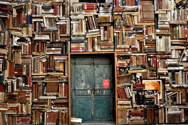 Vintage Wooden Door Surrounded by Stacked Antique Books - Download Free Stock Photos Pikwizard.com