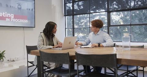 Diverse Colleagues Collaborating in Modern Office Meeting Room