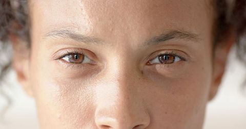 Close-up portrait of woman with natural skin and freckles