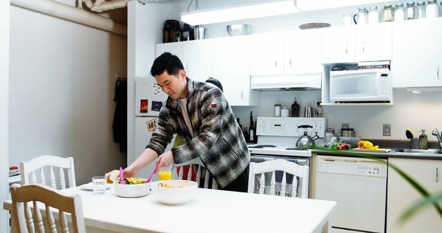 Young Man Preparing Meal in Bright Modern Kitchen - Download Free Stock Images Pikwizard.com