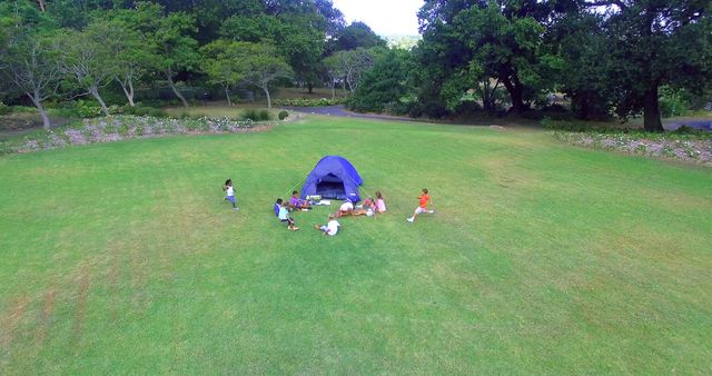 Children Playing Around Blue Tent in Open Field - Download Free Stock Images Pikwizard.com