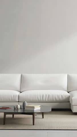 Vertical video showing minimalist living room with white sofa and coffee table, cozy neutral interio