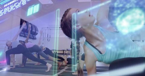 Young woman performing side-plank in group yoga class with futuristic holographic overlay