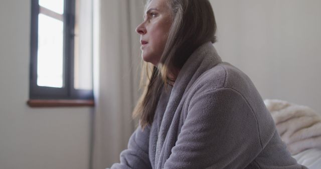 Woman Contemplating by Window in Morning Light - Download Free Stock Images Pikwizard.com