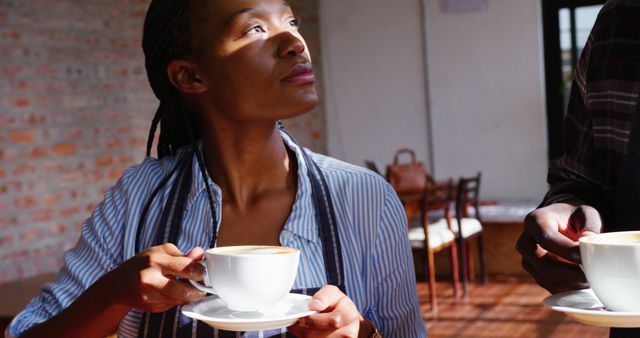 African American woman enjoying coffee in a café - Download Free Stock Images Pikwizard.com