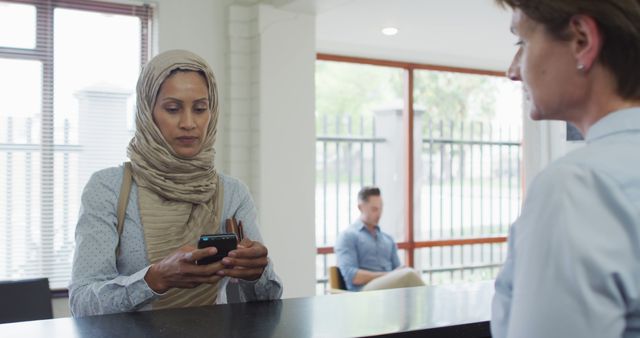 Muslim Woman Processing Transaction in Modern Bank - Download Free Stock Images Pikwizard.com