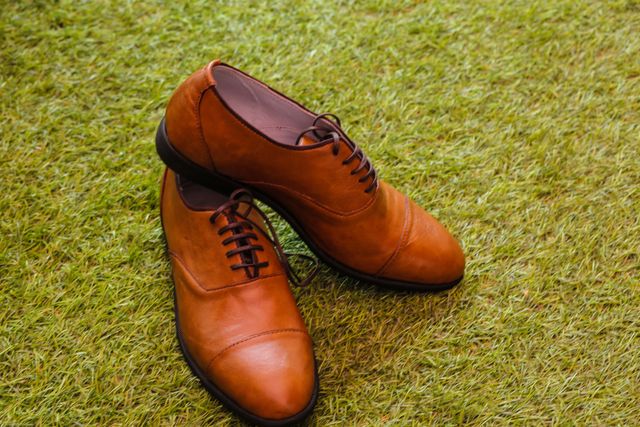 Pair of Brown Leather Shoes on Grass Lawn - Download Free Stock Photos Pikwizard.com