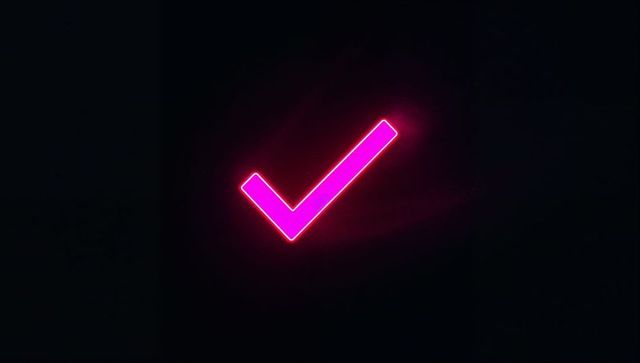 Glowing neon pink check mark in futuristic digital space