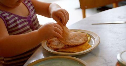 Young Girl Enjoying Delicious Homemade Pancakes