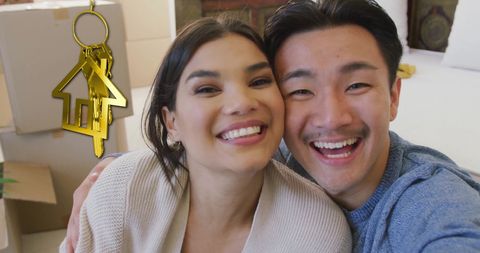 Happy couples celebrating new home with house key