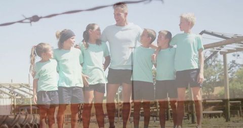 Coach Motivating Young Athletes on Outdoor Training Field