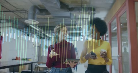 Innovative Businesswomen Analyzing Digital Financial Data in Modern Office