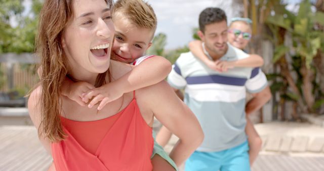 Happy Families Enjoying Piggyback Ride Outdoors - Download Free Stock Images Pikwizard.com