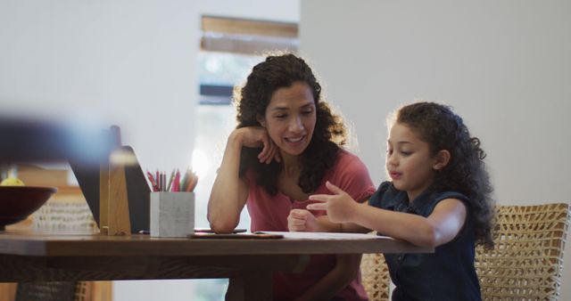 Happy Biracial Mother and Daughter Doing Homework Together at Home - Download Free Stock Images Pikwizard.com