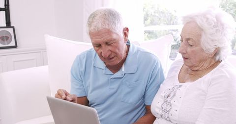 Senior Couple Engaging with Technology on Sofa - Download Free Stock Images Pikwizard.com
