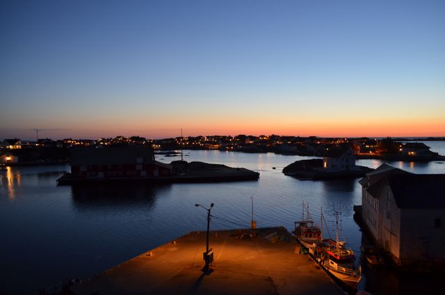 Sunset Over Coastal Village with Calm Waters and Boat Dock - Download Free Stock Images Pikwizard.com