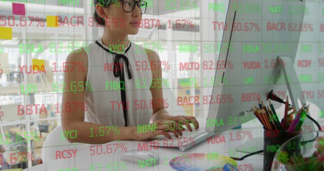 Young woman wearing glasses working at a computer in an office environment, with stock market data overlay. This can be used for themes related to financial analysis, trading, investment strategies, business environments, and advanced technology in financial sectors.