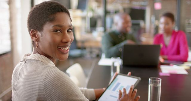 Young African American Woman Collaborating in Modern Office with Tablet - Download Free Stock Images Pikwizard.com