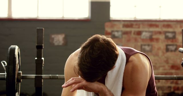 Exhausted Young Man Resting After Intense Workout in Gym - Download Free Stock Images Pikwizard.com