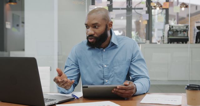 Focused Businessman Holding Digital Tablet During a Video Call in Office - Download Free Stock Images Pikwizard.com