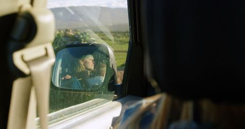Contemplative Woman Reflected in Car Mirror in Scenic Landscape - Download Free Stock Images Pikwizard.com