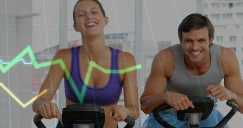 Couple Pedaling Spin Bikes Smiling During Cardio Workout with Data Graph Overlay