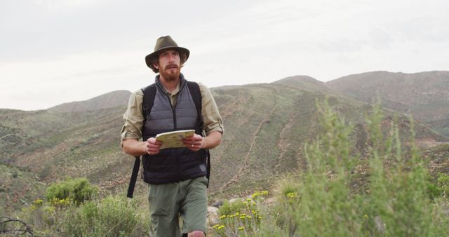 Male Explorer Navigating in Mountain Wilderness - Download Free Stock Images Pikwizard.com