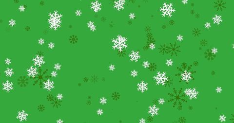Snowflakes Falling on Lush Green Background