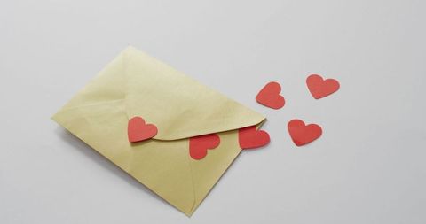 Envelope with red hearts symbolizing love and affection