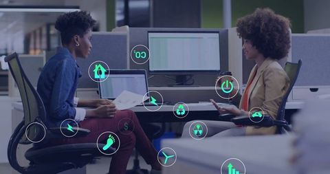 Businesswomen Planning Sustainable Strategies in Modern Office