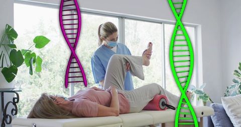 Masked physical therapist assisting senior woman with leg stretch in bright rehab with dna graphics