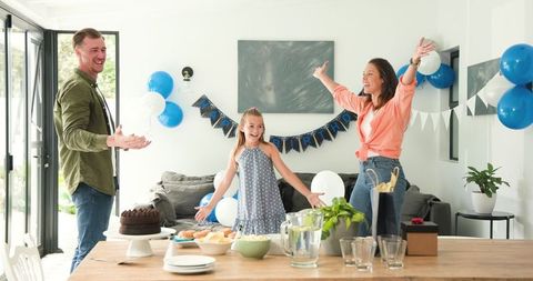 Happy family celebrating daughter's birthday at home