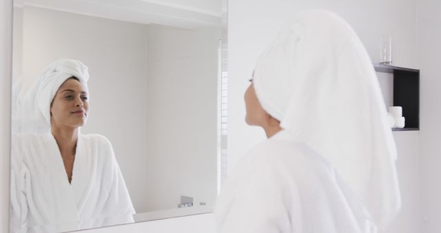 Woman in Bathrobe with Towel Turban Looking into Bathroom Mirror - Download Free Stock Images Pikwizard.com