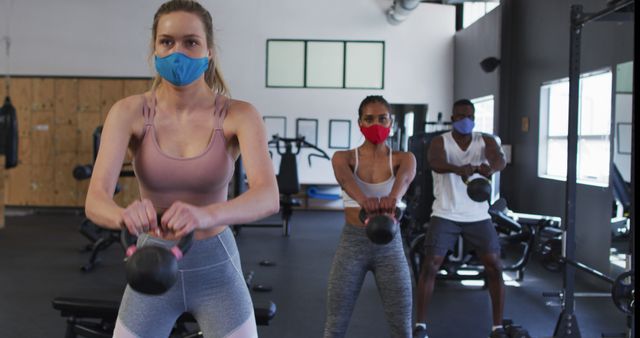 People Exercising with Kettlebells in Gym Wearing Masks - Download Free Stock Images Pikwizard.com