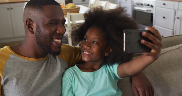 Father and daughter taking selfie in living room - Download Free Stock Images Pikwizard.com