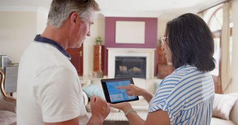 Couple Exploring Smart Home Technology in Stylish Living Room