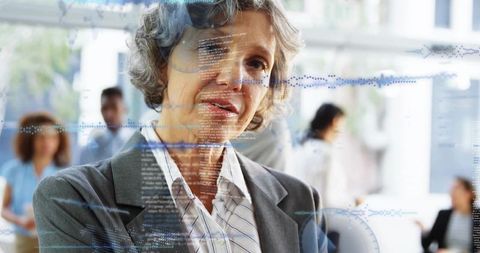 Senior executive analyzing digital data overlays in office, leading tech-driven strategy