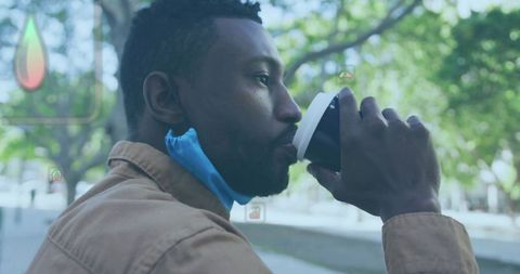 Man Enjoying Coffee in Urban Park Amidst Soothing Nature