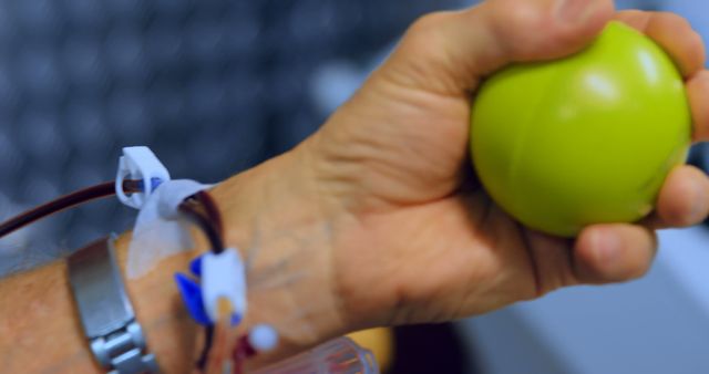 Close-up of Donor's Hand Squeezing Stress Ball During Blood Donation - Download Free Stock Images Pikwizard.com