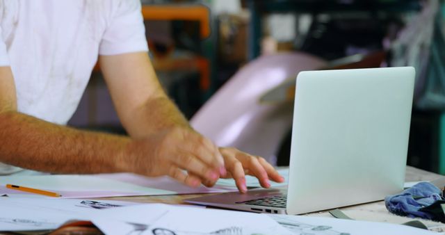 Engineer Working on Laptop with Blueprints in Workshop - Download Free Stock Images Pikwizard.com