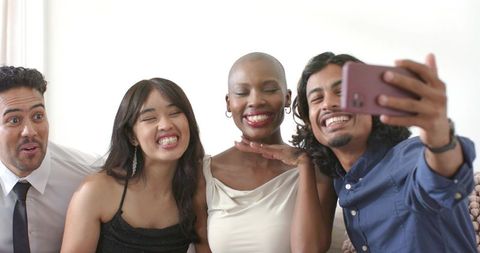 Friends taking selfie on bright living room couch celebrating friendship and style