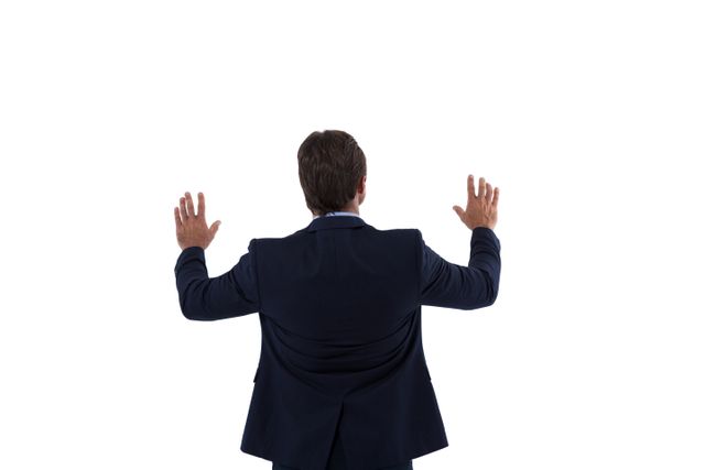 Rear view of businessman touching the invisible screen against white background