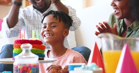 Happy Family Celebrating Boys Birthday With Cake And Candles