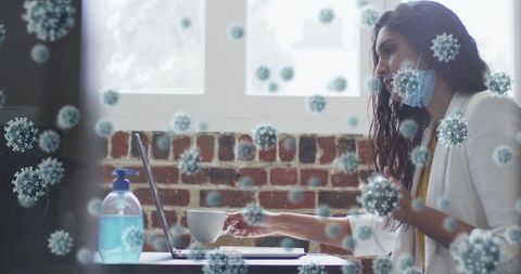 Businesswoman in mask working in covid-impacted office