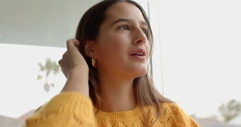 Woman Gazing Out of Window in Relaxed Lifestyle Moment