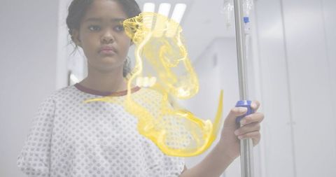 Child patient standing holding iv pole in hospital corridor with yellow medical overlay